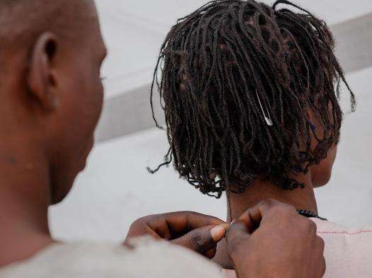 Seember’s son Fanan braids his mother’s hair.