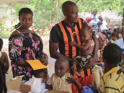 Families and children wait for vaccination in DRC. 