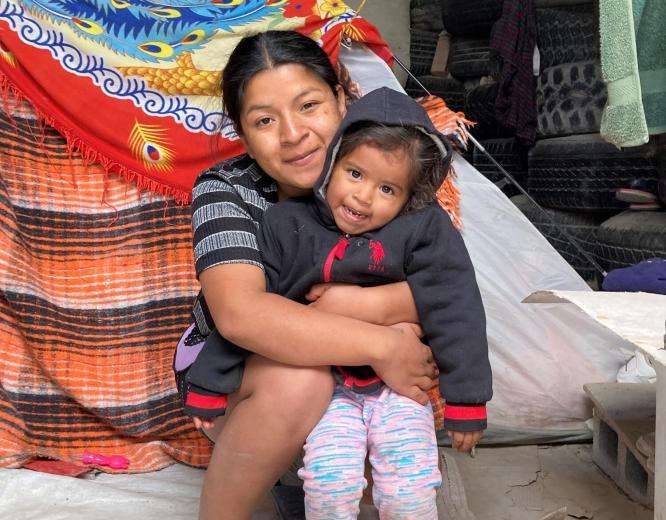 A woman hugs her child in Mexico after migrating from Honduras.