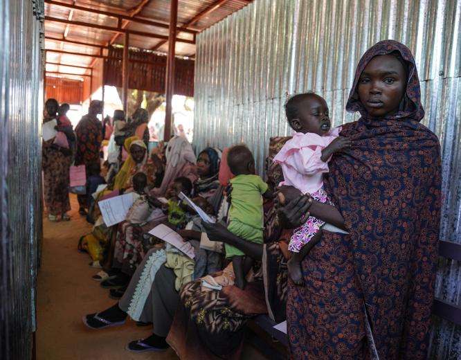 A mother holds her child at MSF's clinic in Zamzam camp in Sudan.