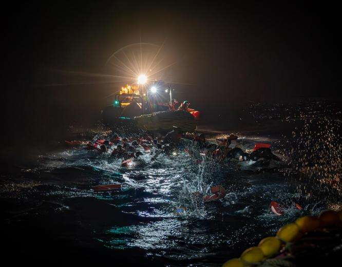 MSF search and rescue team rescues people from a boat in distress in the Central Mediterranean.