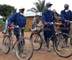 An MSF spraying team arrives in a village to treat houses against mosquitoes