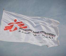 White flag of Doctors Without Borders/Médecins Sans Frontières (MSF) against the sky