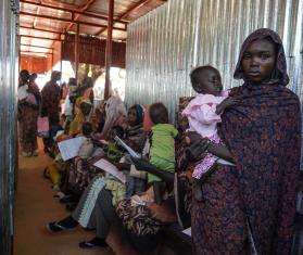 A mother holds her child at MSF's clinic in Zamzam camp in Sudan.