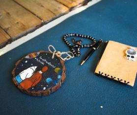 A notebook, prayer beads, and wooden disk carried by a migrant in the Mediterranean Sea. 