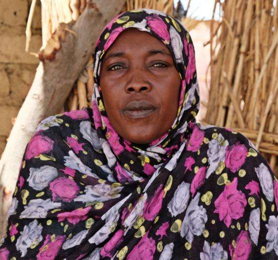 A Sudanese refugee woman in a colorful floral scarf in Chad.