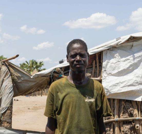 A man stands in front of a treatment center in South Sudan. 